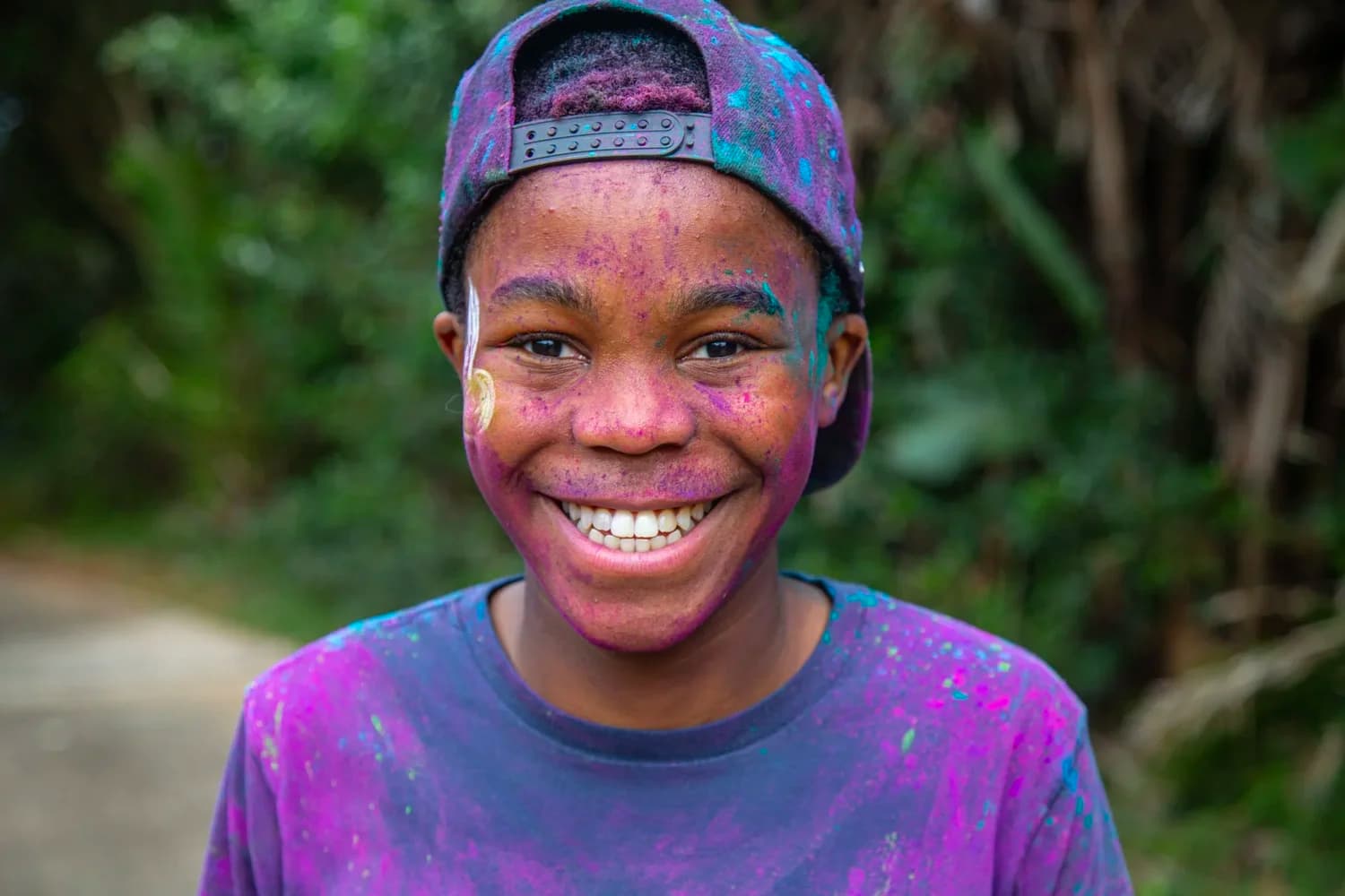 A smiling participant at the Zimbali Estate Colour Run.